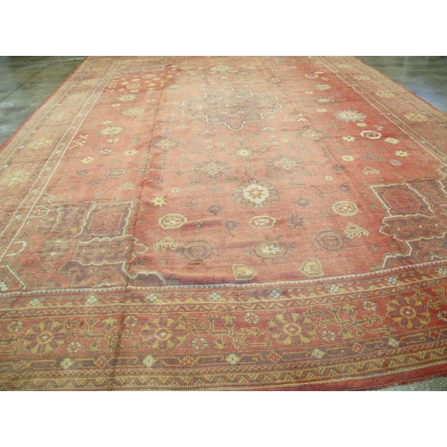 An antique Turkish Oushak oversize carpet handmade during the early 20th century. This is an amalgam of Turkish carpet...