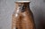 Here is a piece unlike any other: a glazed stoneware bottle vase, crafted by an artist's hands in the 1960s or 70s. Its...