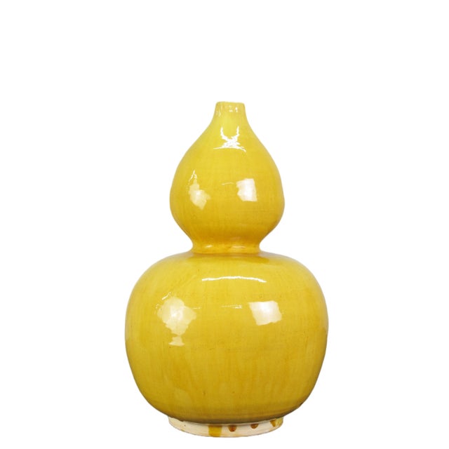 This yellow vase is handmade and hand glazed porcelain pottery. Each piece is unique due to the natural variance created...