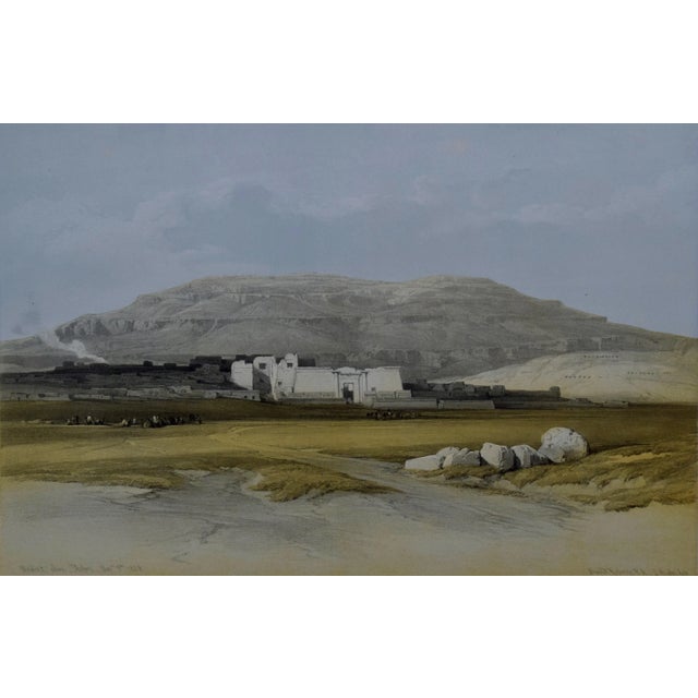 "Medinet Abou, Thebes" is a 19th century folio sized hand-colored lithograph from the Egypt and Nubia volume of David...