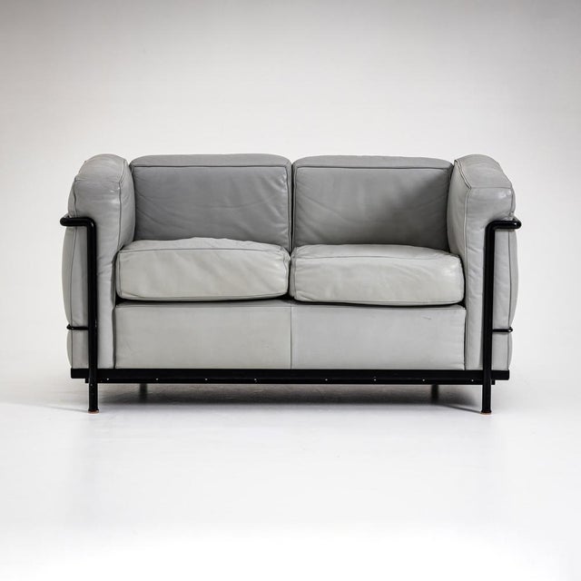 Two-seater leather sofa Grand Confort, Petit Modèle, originally designed by Le Corbusier, Pierre Jeanneret, and Charlotte...