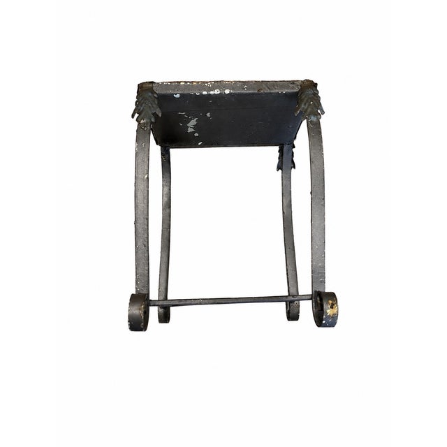 A wonderfully atmospheric antique vanity stool or petite decorative footstool featuring an ornate metal scroll-form base...