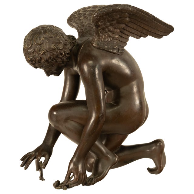 An incredible antique 19th century French bronze of Cupid seated on a gilt ormolu marble column, cupid shown feeding rose...