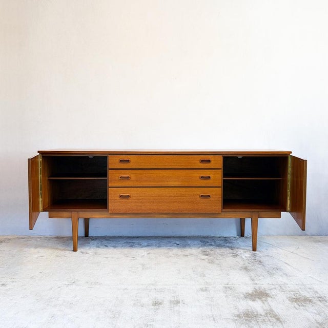 A handsome low sideboard from Nathan's sought-after Citadel range, with rich teak colouring and beautifully figured grain...