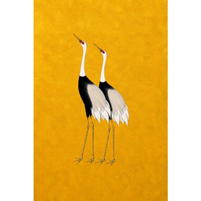 A striking crane triptych featuring elegant black-and-white cranes set against a rich golden backdrop. Designed as a...