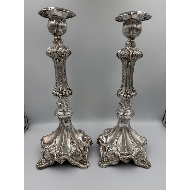 A highly decorative pair of Baroque Revival candlesticks, distinguished by their sculptural form and richly modeled...