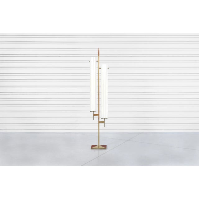 A stunning vintage brass floor lamp, a true gem from the 1970s, reminiscent of the exquisite craftsmanship found in pieces...