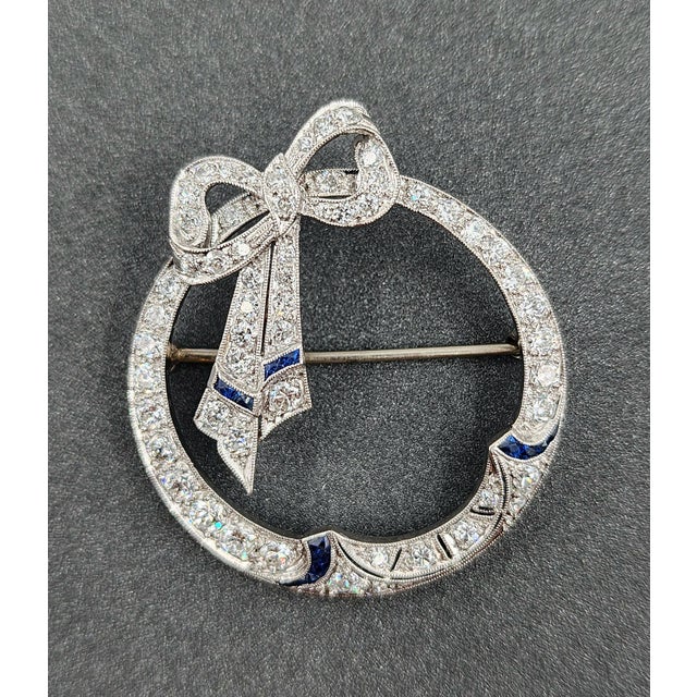 This stunning natural sapphire and diamond brooch is sure to turn heads. Approximately 3.00 ctw, the diamonds boast a...