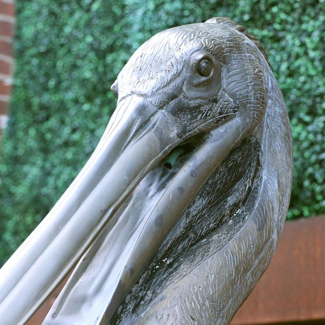 A monumental bronze fountain sculpture, signed "S David", depicting a pelican perched atop a nautical dock piling wrapped...