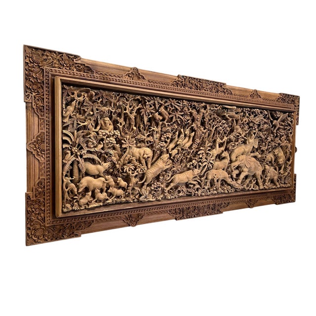 Monumental Indonesian architectural wall panel, hand-carved from solid teak in deep high relief with pierced openwork. The...