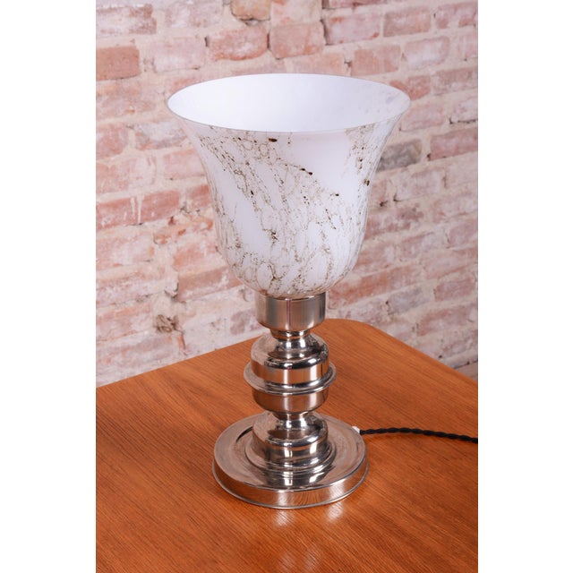 This elegant table lamp is a premier representative of Czechoslovak Art Deco design, dating back to the 1920s. It is...
