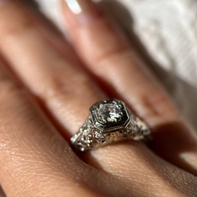 An exquisitely preserved Art Deco diamond filigree engagement ring, crafted in solid 18K white gold and dating to the...