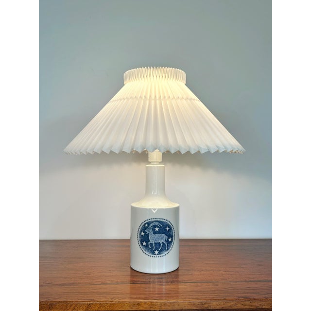 A rare Zodiac table lamp designed by Kaj Lange for Royal Copenhagen and Fog & Mørup in the 1970s. Featuring the Capricorn...