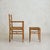 A 1950s French armchair and ottoman, crafted in solid wood with a handwoven rope seat. The frame is defined by its honest...