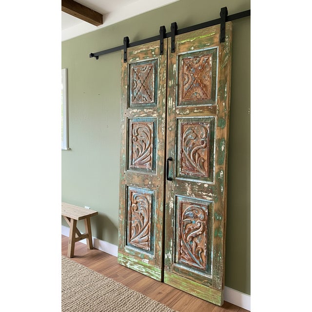 Infuse your home with soulful character using this vintage hand-carved double barn door, beautifully finished in vibrant...