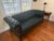 This dark green leather and walnut Chesterfield sofa is from the late 19th century. It has a tufted rectangular back and...
