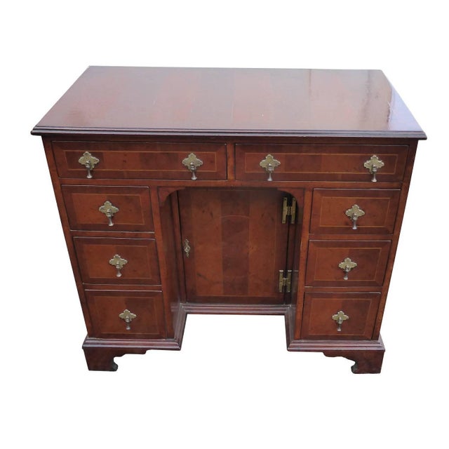 A good quality Queen Anne style oyster shell and inlaid kneehole desk. The top of the desk has three inlaid circles and is...