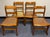 Striking set of four solid Birds Eye maple American classical or Federal style cane seat dining chairs. The chairs feature...