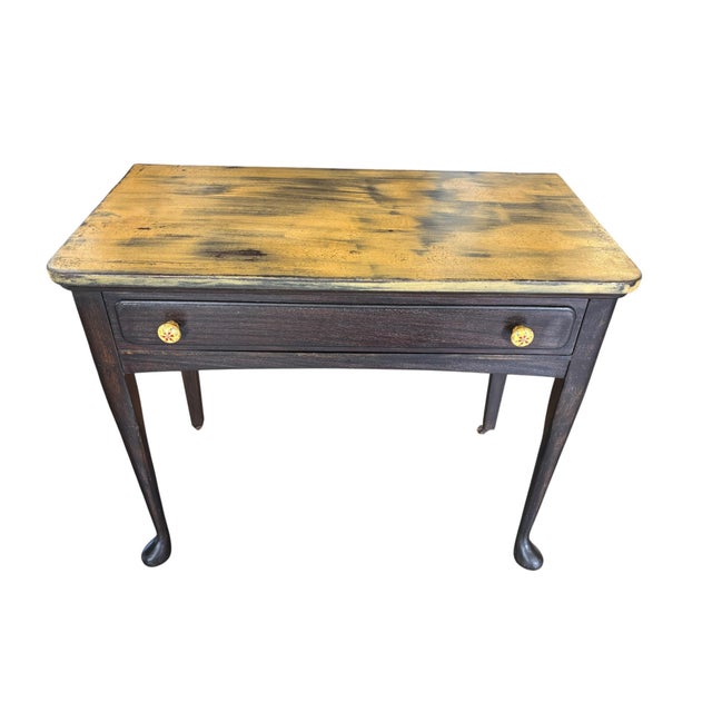 Charming vintage writing table or petite console featuring a slender dark-stained wood frame, elegant tapered legs and a...