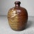 This earthenware jug from the Taishō period is a stunning example of traditional Japanese craftsmanship from Nagoya....