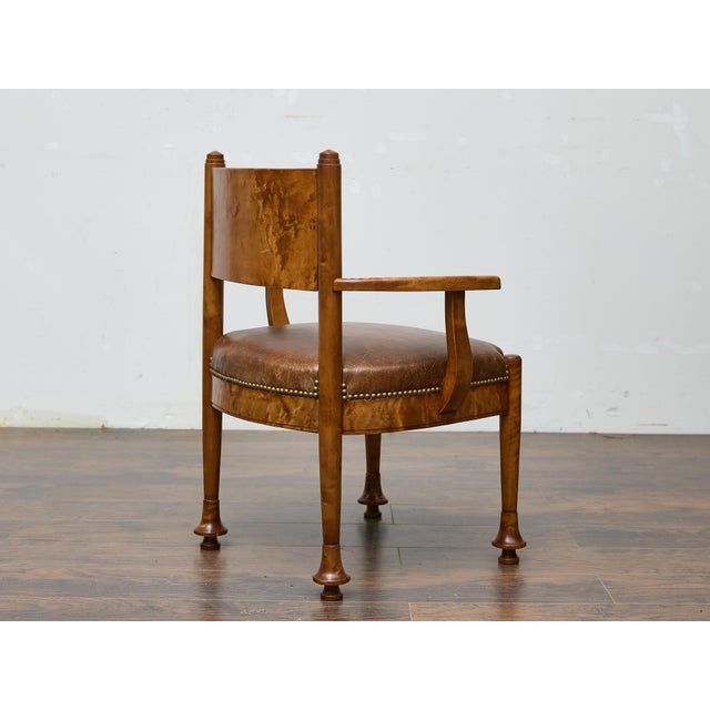 A finely crafted English armchair in burl wood, dating to the early 20th century, featuring a rich combination of clean...
