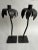 A matching pair of wrought iron palm tree shaped candlestick holders on square bases.