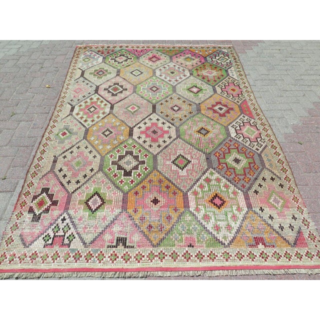 This beautiful, traditional vintage, flatweaved Turkish kilim rug is approximately 60 years old. It is handmade of very...