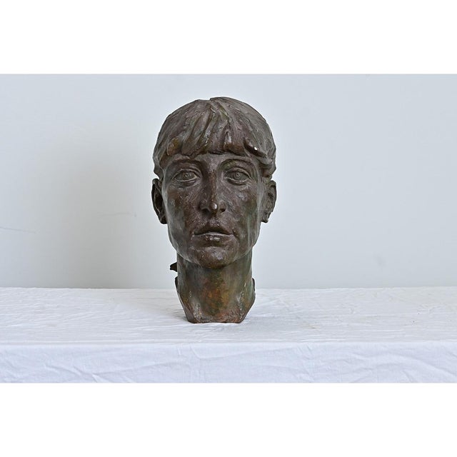 A monumental French vintage bust of an anonymous young woman in larger-than-life scale, her unforgettable likeness...