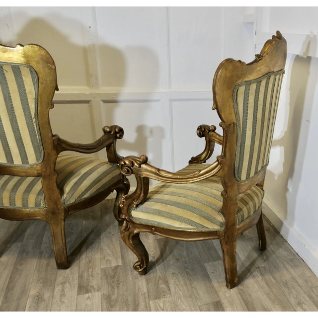 A Pair of Large Italian Carved GiltWood Arm Chairs These large arm chairs are very comfortable the arms legs and back are...