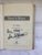 A 9 x 6 Hardbound Book with Original Jacket signed by Author Eli Gold who was known as The Voice of the University of...