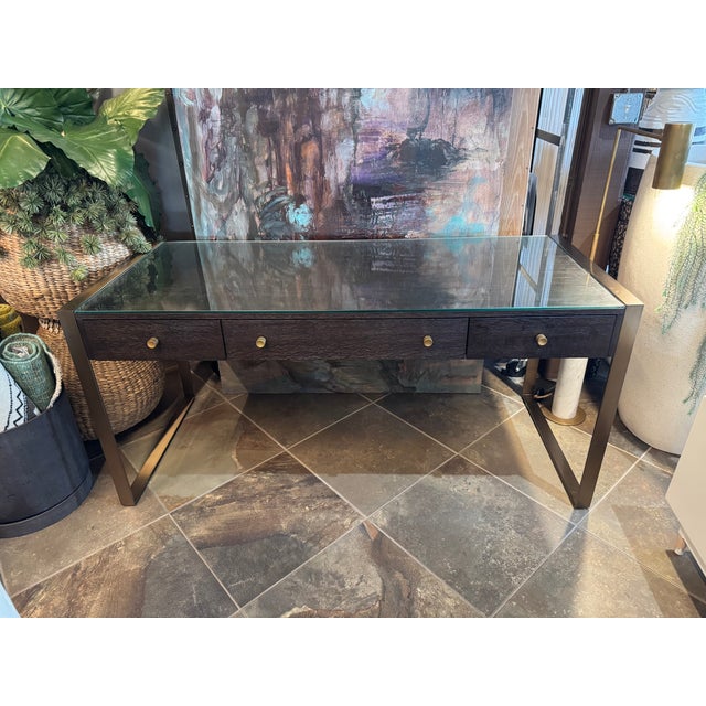 Bringing together the rich Midnight finish and soft brushed brass legs, the Curata writing desk offers three drawers...