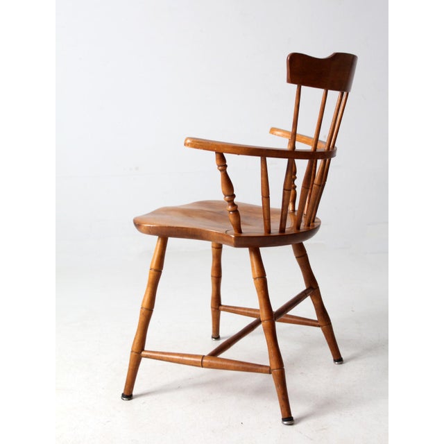 From the mid-20th century, this vintage Nichols & Stone Windsor chair features a classic comb-back design with turned...