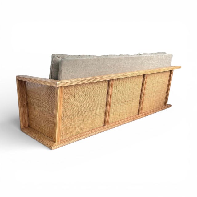 A stunning three seat sofa in rattan and cane webbing, manufactured by Lane Venture of North Carolina circa 2011. Possibly...