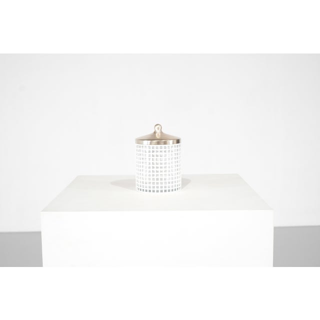 White lacquered metal sugar bowl with glass lid and metal lid. Manufacturer's label underneath. Designed by Josef Hoffmann...