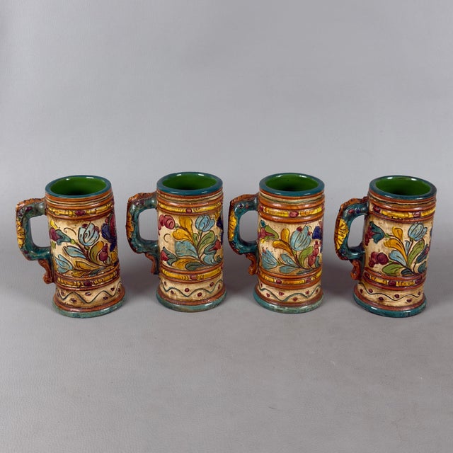 A rare and unique collector's set of four beer mugs, a pure expression of Umbrian folklore and ceramic excellence. These...