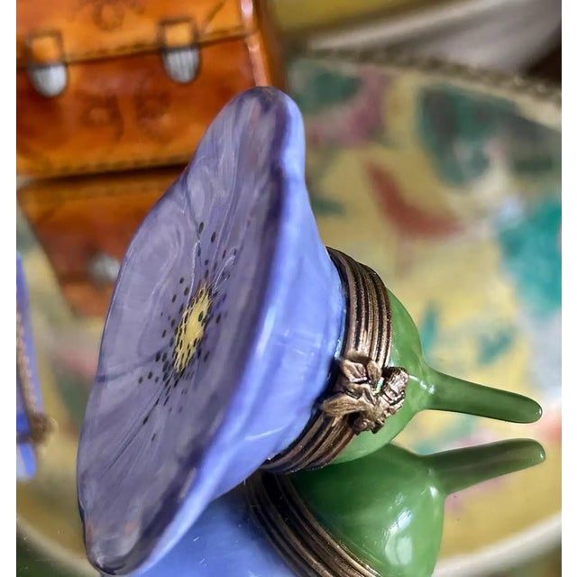 Limoges porcelain trinket box, hand-painted in France and finished with fine detail and rich color. The box features a...