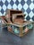 Set of three graduated and nesting vintage Indian wooden nesting boxes with hand-painted figural decoration. Each box has...