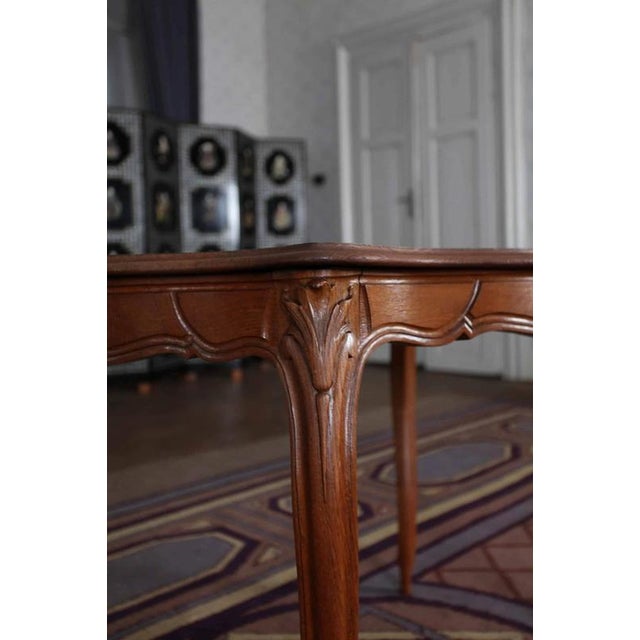 The table is hand-carved from solid oak. The top and side are decorated with molding. The legs in the shape of doe legs...