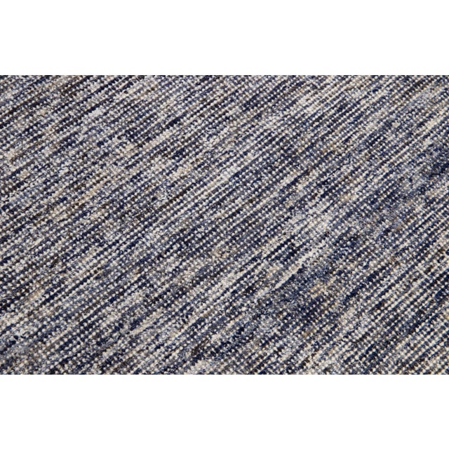 Beautiful Apadana's handmade bamboo/silk & wool Indian groove rug with a blue field. This groove collection rug has an...