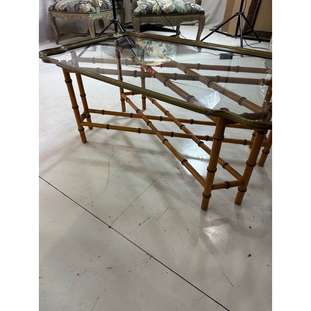 Regency style faux Bamboo glass with heavy brass rim… A unique coffee table for an elegant setting. The patina is...
