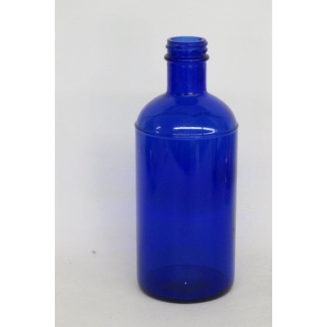 This stunning Medicine / Apothecary Bottle is made out of glass. Presenting a vibrant cobalt blue color, this authentic...