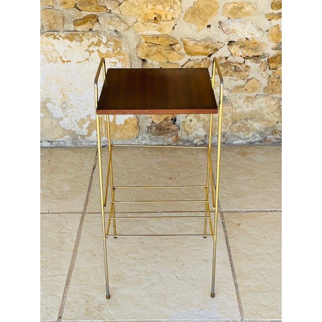 Mid-century,Vintage two tiered side table circa 1960s. The top shelf is made of wood with a striped mahogany colored...