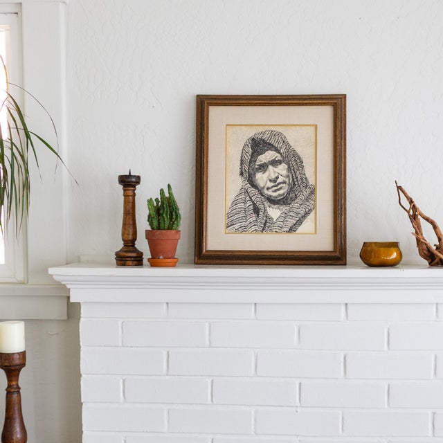 An early 20th-century pen and ink portrait of an old woman wearing a head scarf features an abundance of texture, shadow,...