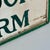 1930s Joyful Double Sided Wooden Trade Sign Advertising "Bubbling Brook Farm" in Green Paint For Sale - Image 9 of 10