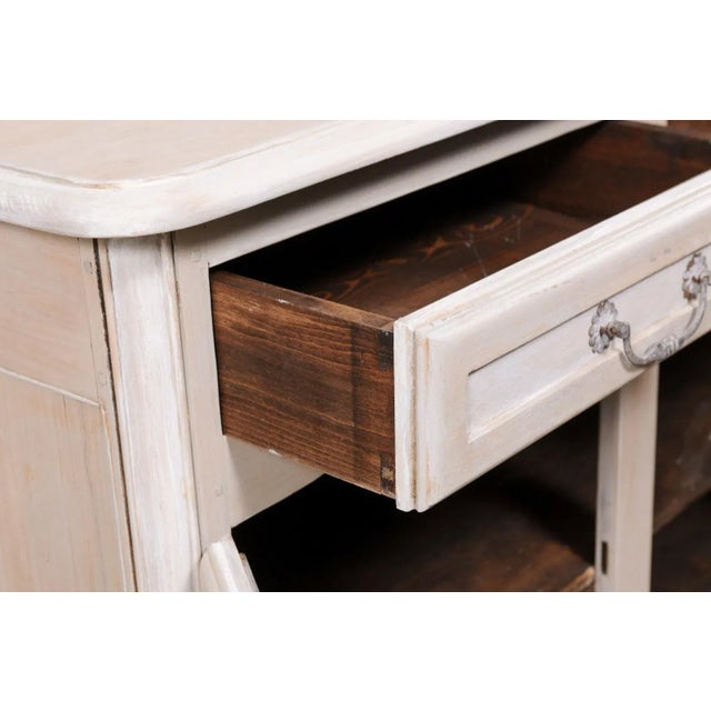 A French painted sideboard cabinet from the mid 20th century. This mid-century cabinet from France, over 6.5 feet in...