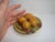 Delightful rustic European small scale antique majolica plate stacked with 4 life-size nuts, which I believe to be either...