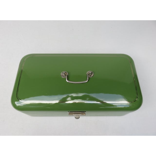 A forest green enameled bread box from the Art Nouveau period. The lid is decorated with two enameled silver stripes...