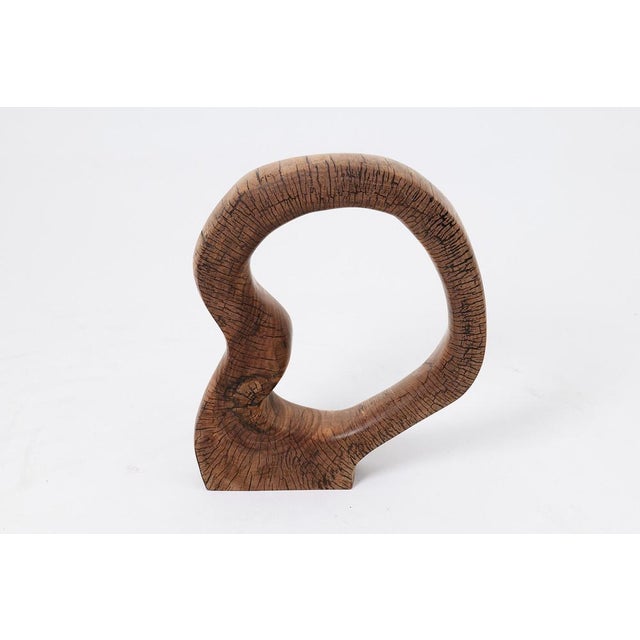 This captivating sculpture is a one of a kind piece, hand carved from a single block of solid hardwood. Its form is a...