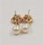 This is part of Chairish’s Costume Jewelry assortment. c1990 goldtone pink resin flowers with faux-pearl center and faux-...