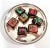 A charming vintage holiday display featuring seven highly realistic faux decorated chocolates arranged on a round...